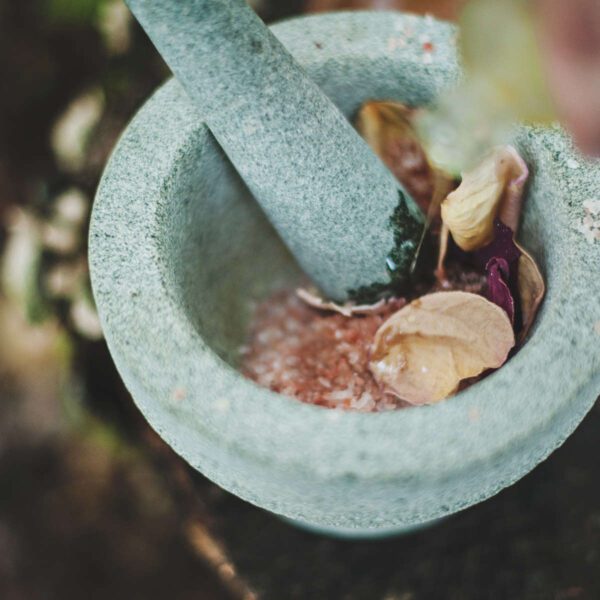 A mortar and pestle with some food inside of it