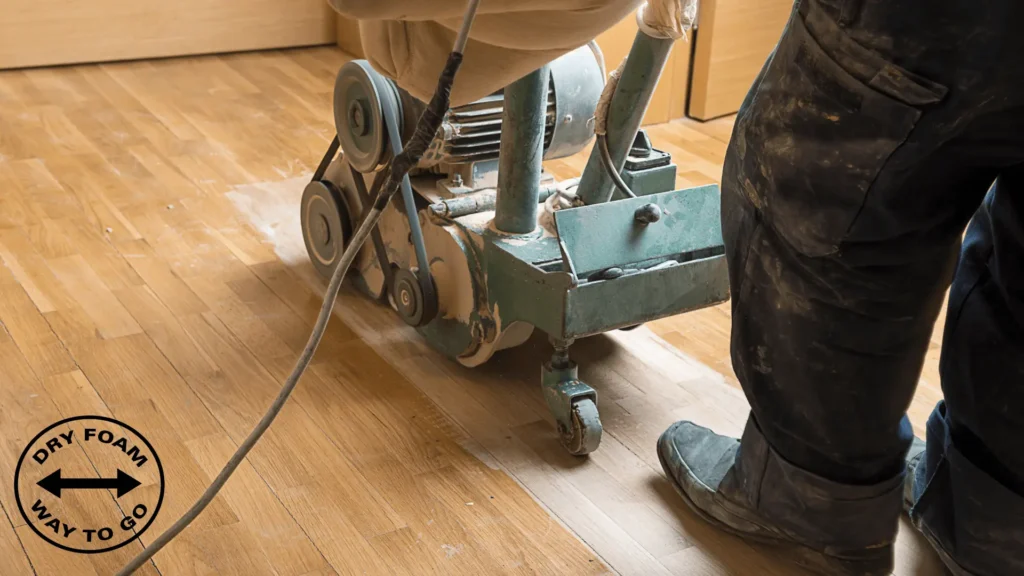 A person standing next to a machine on the floor.